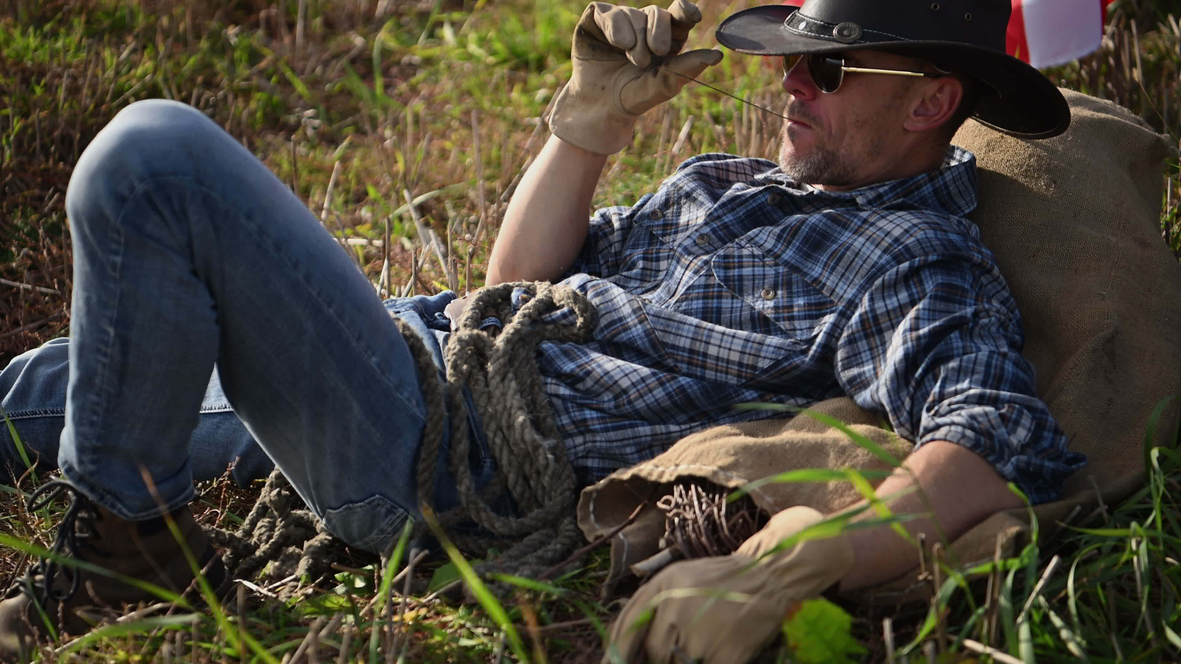 Cowboy Chiiling Out and Chewing a Piece of Straw 24572639 Stock Video