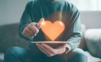 happy enjoying feeling concept, man holding tablet with virtual heart shape thumb up for feedback satisfaction, positive thinking photo