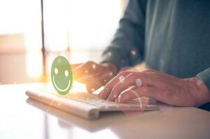 Customer service satisfaction survey concept.Business people or customers show satisfaction by pressing face emoticon smile in satisfaction on virtual touch screen. photo