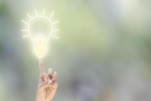 index finger points up for business idea with blub light sketch on blur background photo