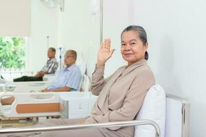 Nursing Home Care concept. A group of elderly people in nursing homes meeting with nursing care assistants photo