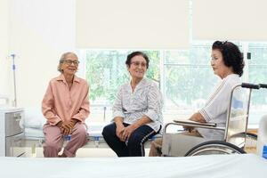 Nursing Home Care concept. A group of elderly people in nursing homes meeting with nursing care assistants photo