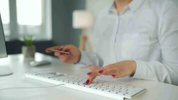 mujer mecanografía crédito tarjeta número en computadora teclado. ella haciendo en línea compra. en línea pago Servicio video