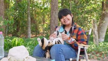 Asian girl sitting with tricolor cat video