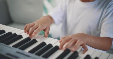 Cute boy enjoy to learning playing piano at home photo
