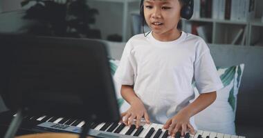 Cute boy enjoy to learning playing piano at home photo