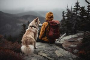 Woman hiking with dog in mountains. photo