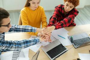 Stack of hands. Business startup teamwork unity concept. Top view of young business people putting their hands together. Business colleagues during the work process rejoice in success of company photo