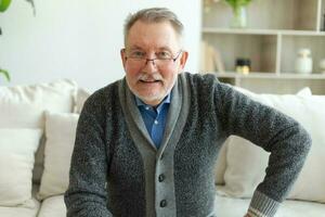 Confident stylish middle aged senior man at home. Older mature 70s man smiling. Happy attractive senior beard grandfather looking camera close up face headshot portrait. Happy people. photo