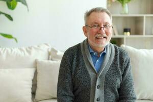 Confident stylish middle aged senior man at home. Older mature 70s man smiling. Happy attractive senior beard grandfather looking camera close up face headshot portrait. Happy people. photo