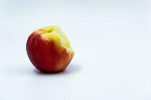 Bitten red apple on white isolated background with shadow. Background. For text. High quality photo