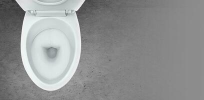 Top view of toilet bowl in the bathroom on cement background photo