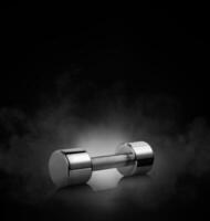 dumbbell with on black background with smoke photo