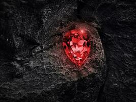 Red diamond on black coal background photo