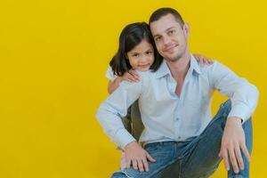 The father sat on the floor as his beloved daughter. photo