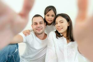 Happy family portrait with parents and little daughter. photo