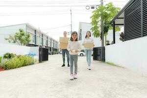 Happy family with girl moving into a new home. photo