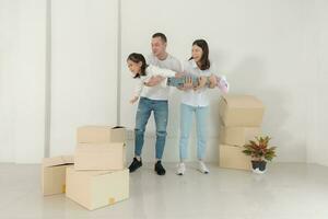 Happy family with girl moving into a new home. photo