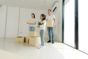 Happy family with girl moving into a new home. photo