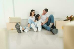 Happy family with girl moving into a new home. photo