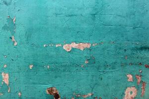 Grunge blue Old wall with peeling paint. Background texture. photo