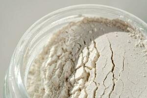 An open jar of face scrub-powder showing off its texture. photo