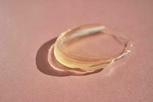 The texture of a yellow transparent gel cosmetic. photo