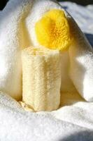 Loofah washcloth and organic sea sponge on the background of towel. photo