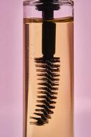 Cosmetic oil for the growth of eyebrows and eyelashes with a brush. photo
