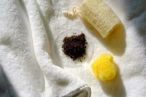 Coffee scrub with two washcloths and a towel. photo