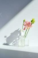 Serum with a dropper with spring flowers. photo