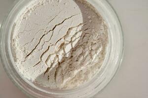 An open jar of face scrub-powder showing off its texture. photo