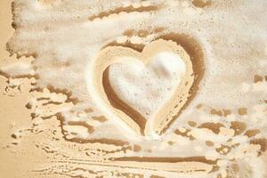 Photo of cosmetic foam or soap with a heart drawn on the foam.