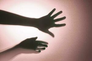 Hand shadows. Concept for illustrating the negative state. photo