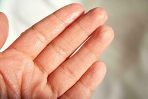 Fingers of the hand after moisturizer. photo