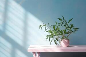 Table with plant in vase against blue wall background. photo