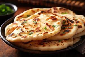 Naan bread in plate. Flatbread with spices. Indian cuisine. photo