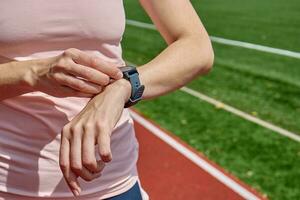 Woman use fitness smart watch, checking results after sport training photo