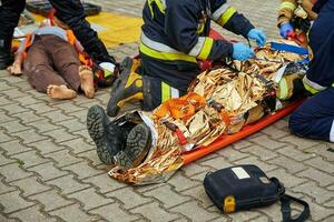 Rescuers provide first aid to the victim during car road accident photo