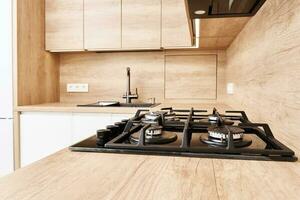 Gas stove with hob in kitchen, close up photo