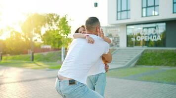 Daughter runs to dad and hugs him. Father picks up the child in his arms video