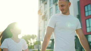 Dad and daughter walk around their area at sunset. Child holds father's hand video