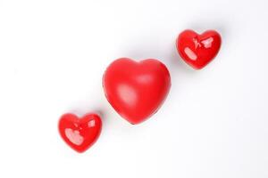 small large three dimension 3d red hart shape symbol on top of white background copy text space top view photo