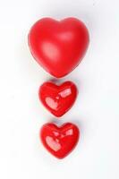 small large three dimension 3d red hart shape symbol on top of white background copy text space top view photo