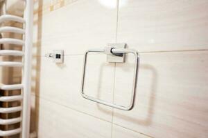 Close up of a steel towel hanger in a modern bathroom. photo