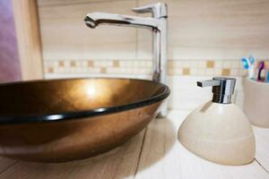 Bathroom faucet and sink with accessories. photo