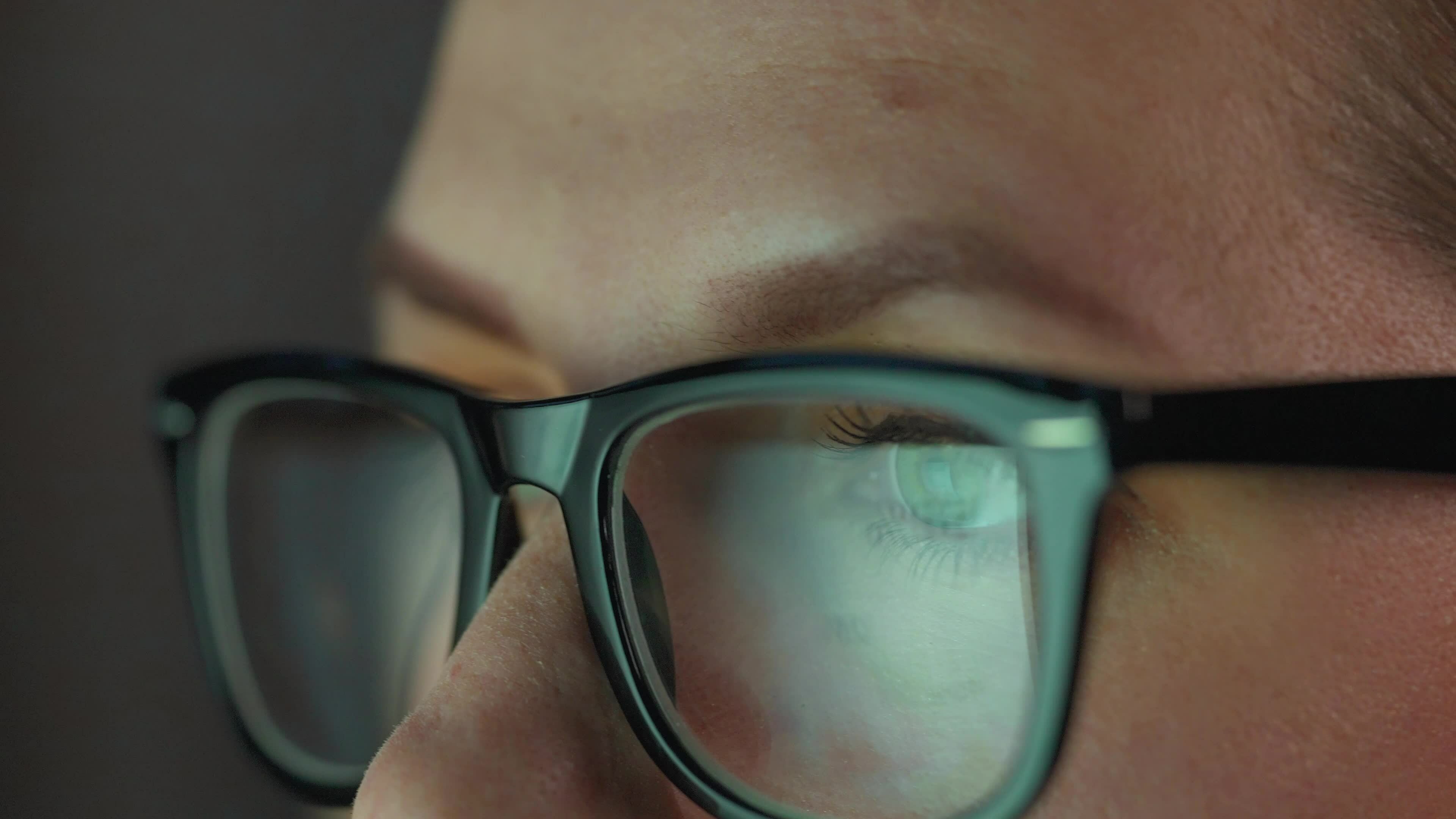 Woman in glasses looking on the monitor and and working with charts and