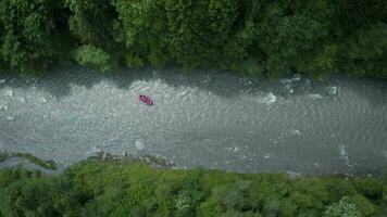 Aerial view of group of people on a rafting trip in an rubber dinghy video