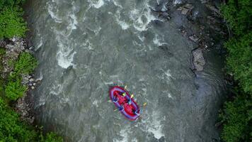 Aerial view of group of people on a rafting trip in an rubber dinghy video