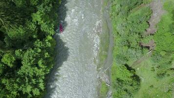 Aerial view of group of people on a rafting trip in an rubber dinghy video